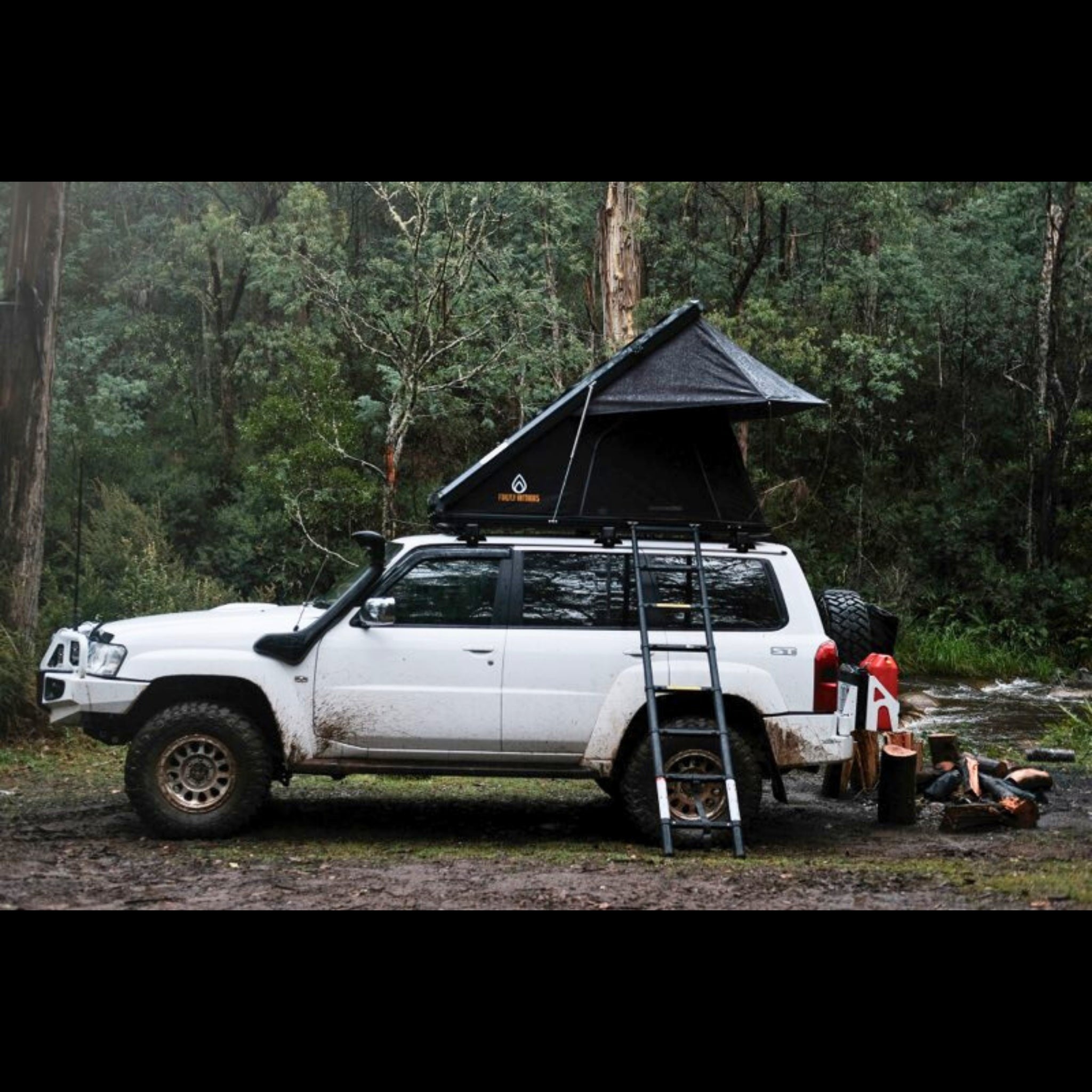 Firefly Outdoors - Phoenix1.3 rooftop tent set up at off‑grid campsite with touring vehicle