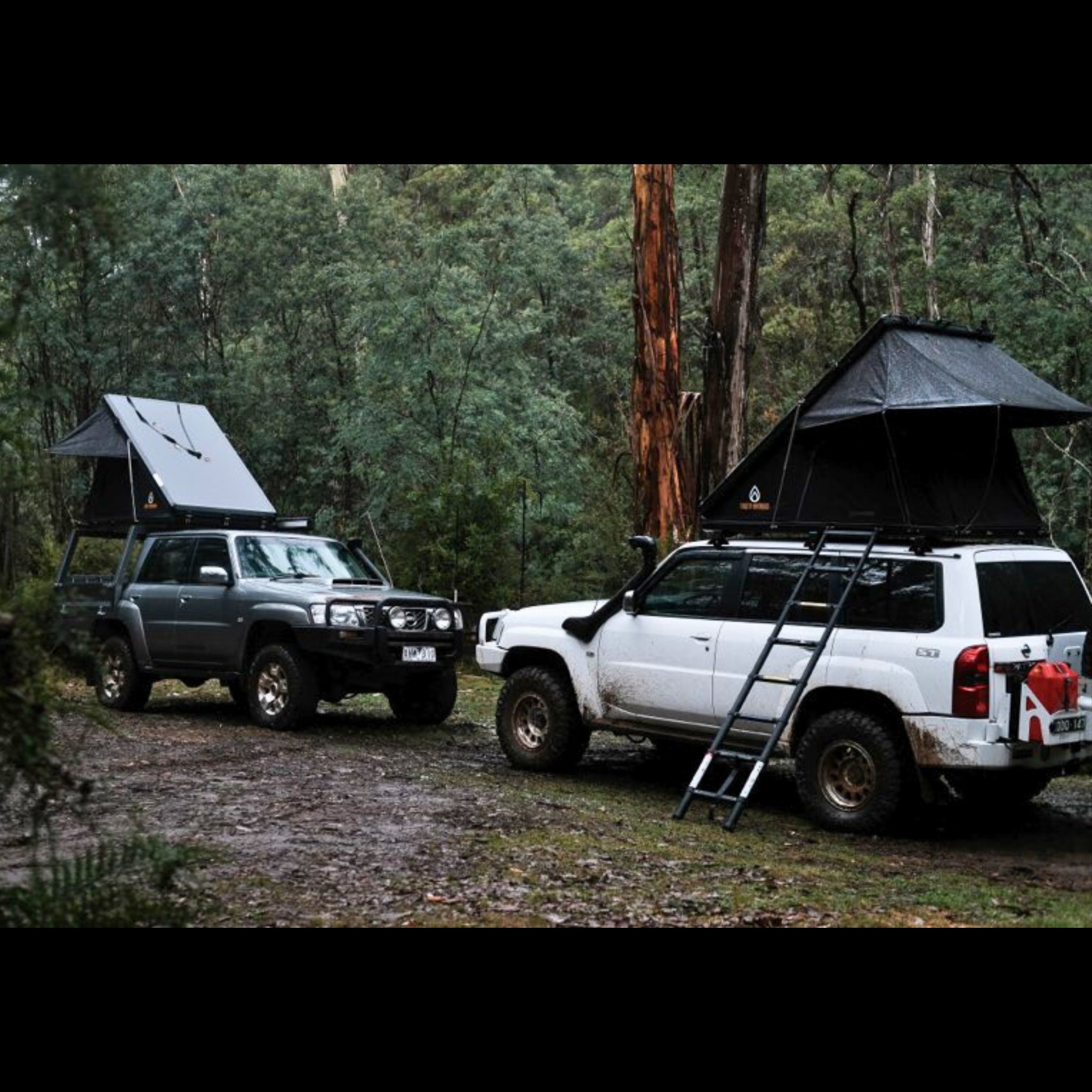 Firefly Outdoors - Phoenix 1.3 rooftop tent set up at off‑grid campsite with two 4wd touring vehicles in forest 