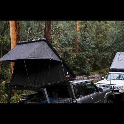 Firefly Outdoors - Phoenix 1.3 rooftop tent set up at off‑grid campsite with two 4wd touring vehicles in forest 