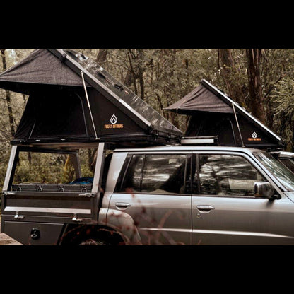 Firefly Outdoors - Phoenix 1.3 rooftop tent set up at off‑grid campsite with two 4wd touring vehicles in forest 