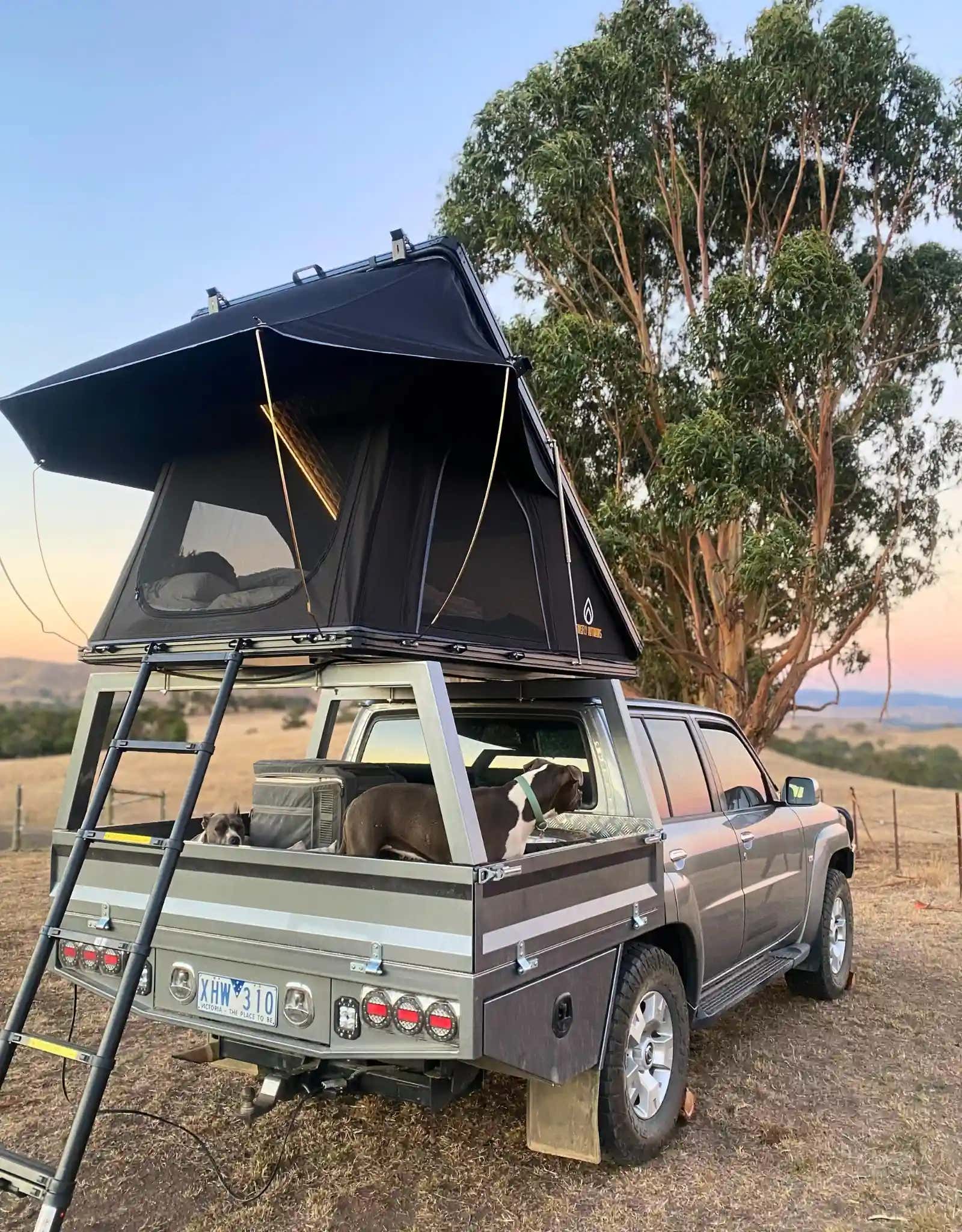 Car with Phoenix 1.3 rooftop tent in a natural settting